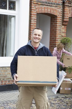 Removal team handling a move in a West Hampstead street with local flats