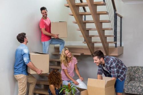 Professional movers handling furniture in a West Hampstead flat