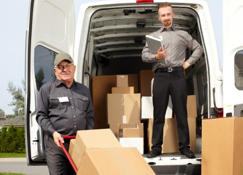 Loading furniture into a moving truck in West Hampstead