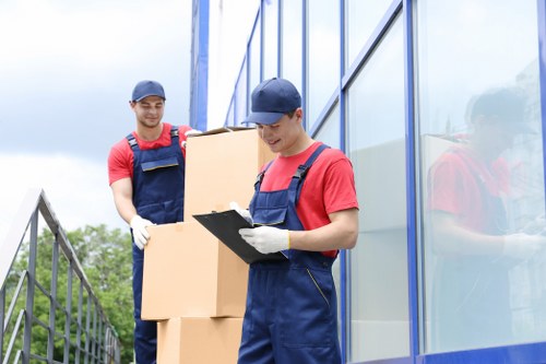 Moving team carrying furniture from a West Hampstead flat