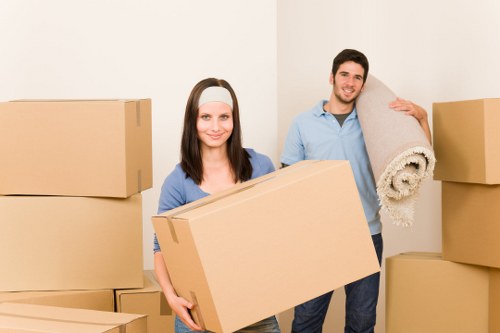 Professional movers preparing sofas and tables for delivery
