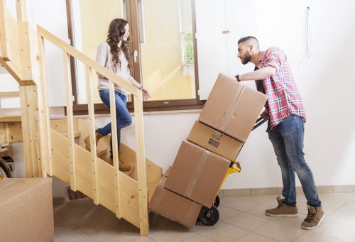Unpacking boxes and arranging belongings in a West Hampstead property