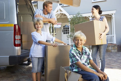 Team loading boxes and household items into a van