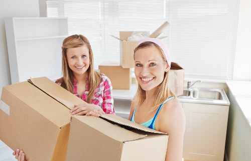 Professional movers handling desks and office boxes in West Hampstead